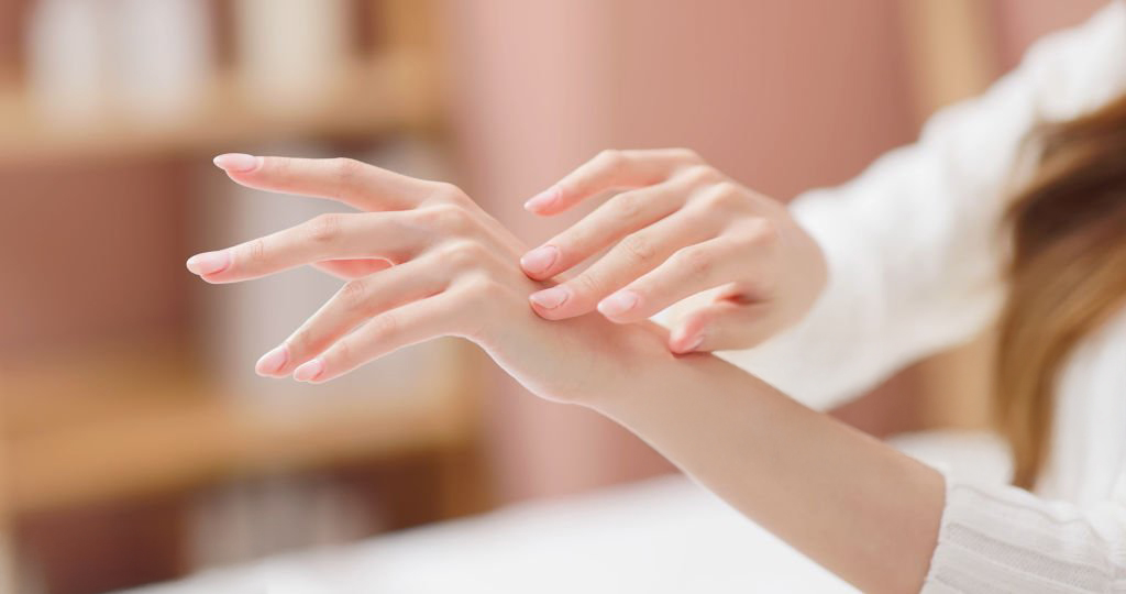 Closeup side view of asian female skincare caress hand and nail in autumn and winter