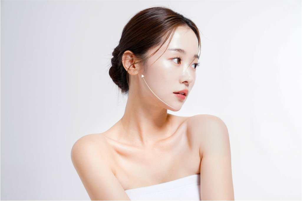 Young woman with lifted jawline after non-surgical face lifting treatment in Singapore, showcasing smooth and firm skin.