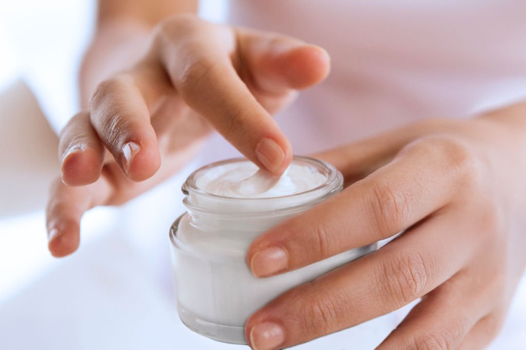 woman's hand touching on the cream for applying