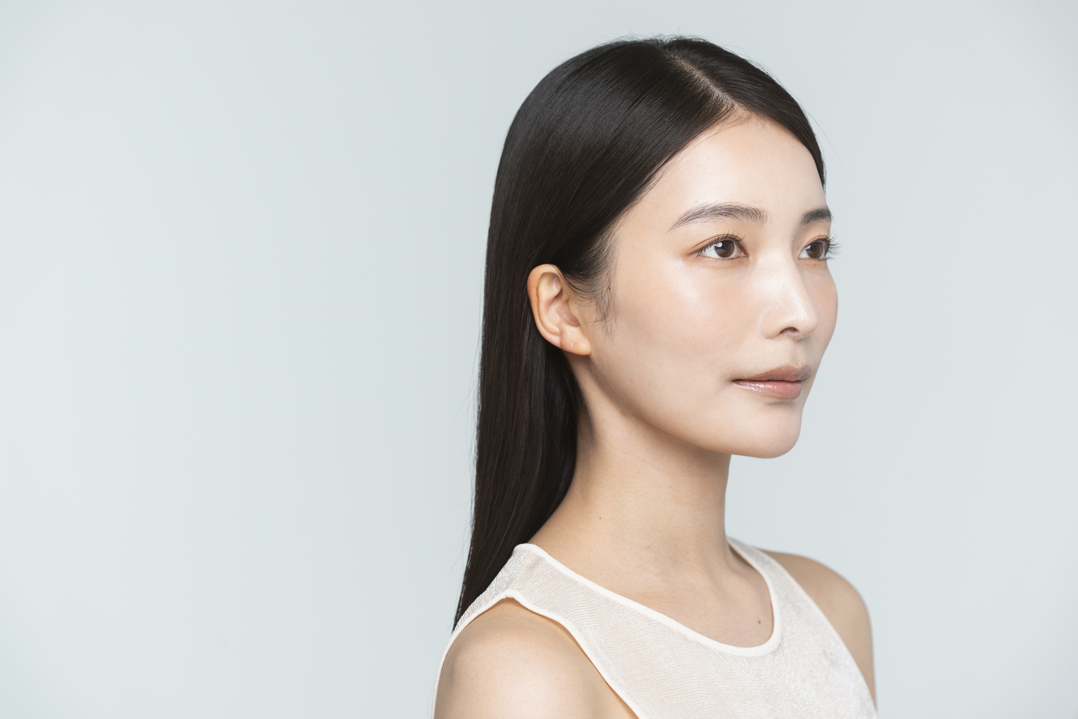 A young black-haired Japanese woman with sculpted chin