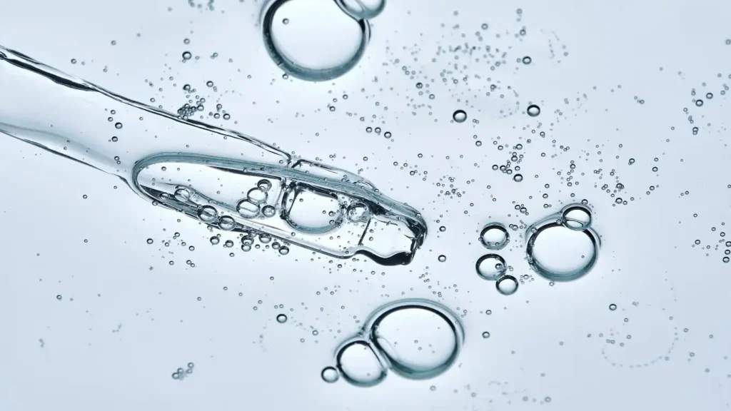 Macro view of clear hyaluronic acid droplets, the foundational component for improving skin moisture balance and quality.