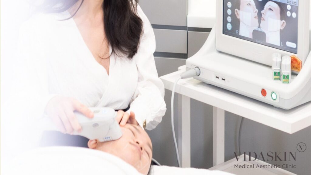 A doctor performing an Ultherapy treatment using the real-time ultrasound visualization screen.