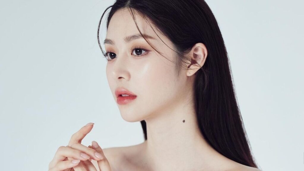 A woman looking off-camera, showcasing a natural and supported facial profile after subtle aesthetic care