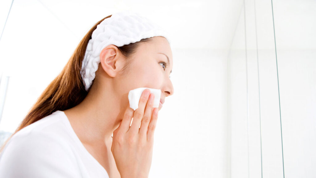 Woman cleansing her face